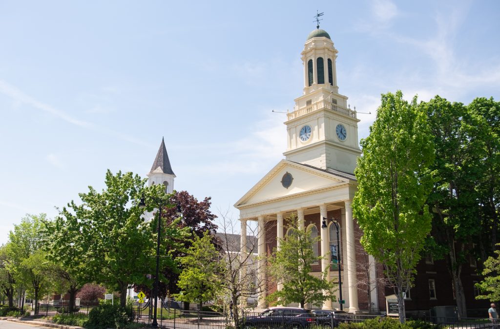 A white building with columns and a gold dome in Pittsfield, MA.
